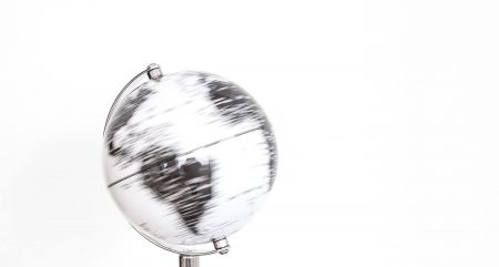 Outsourcing to the Phillippines: a man holding a silver globe in his palm